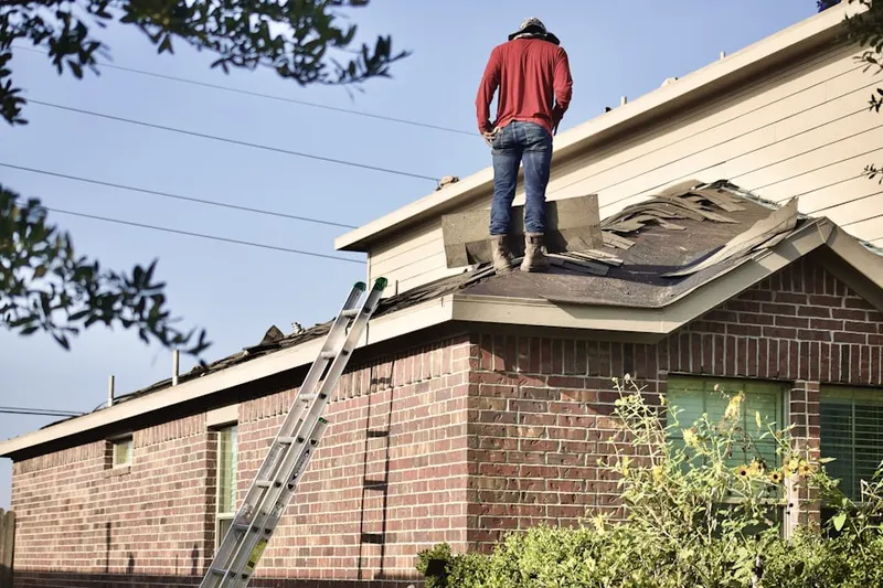 Professional roofer working on a residential roof in Topeka
